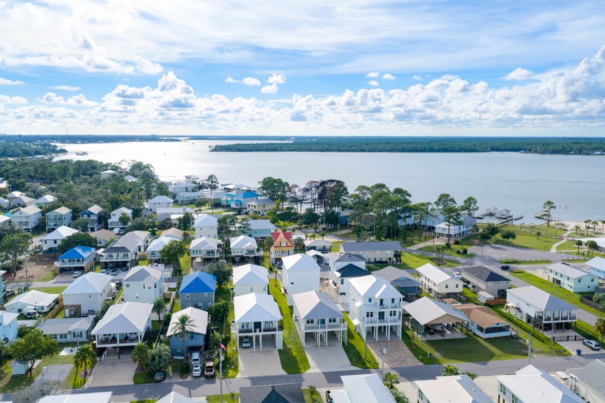 Aerial view of a coastal neighborhood with Perdido Bay in the background